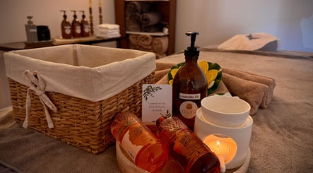 Tranquil massage setup at Rivera Spa and Massage, Christchurch, Canterbury Region, NZ with lavender oils and candles.