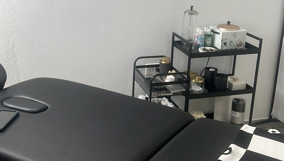 Treatment room at BROWOLOGY, Carolina, San Juan, PR showcasing a massage table and skincare products.