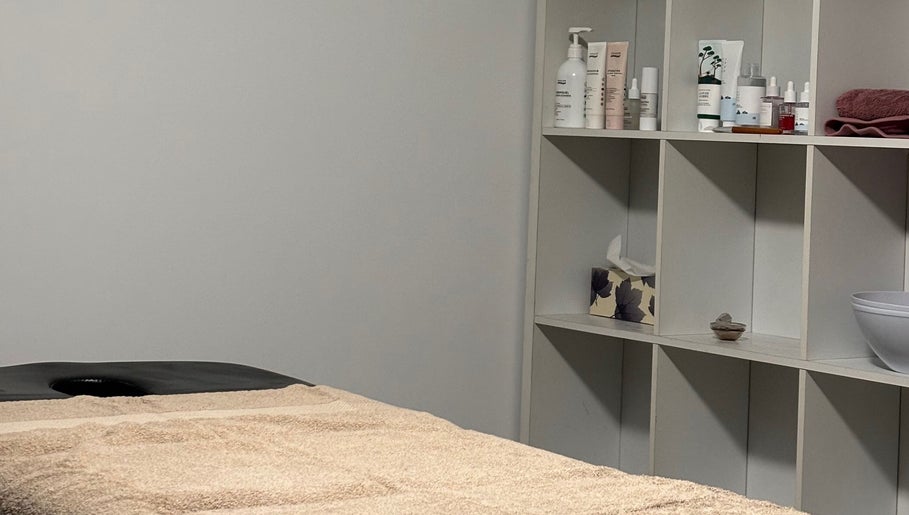 Relaxing treatment room at Rosalie Skin Studio in Morayfield, Queensland, AU, showcasing neatly arranged skincare products.