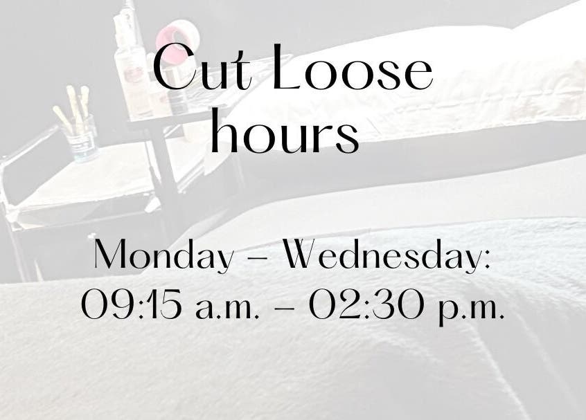 Cut Loose salon hours display table with products in Wigan, England, GB.