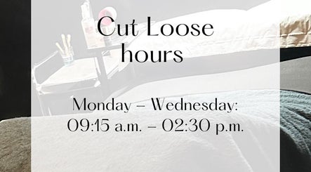 Cut Loose salon hours display table with products in Wigan, England, GB.