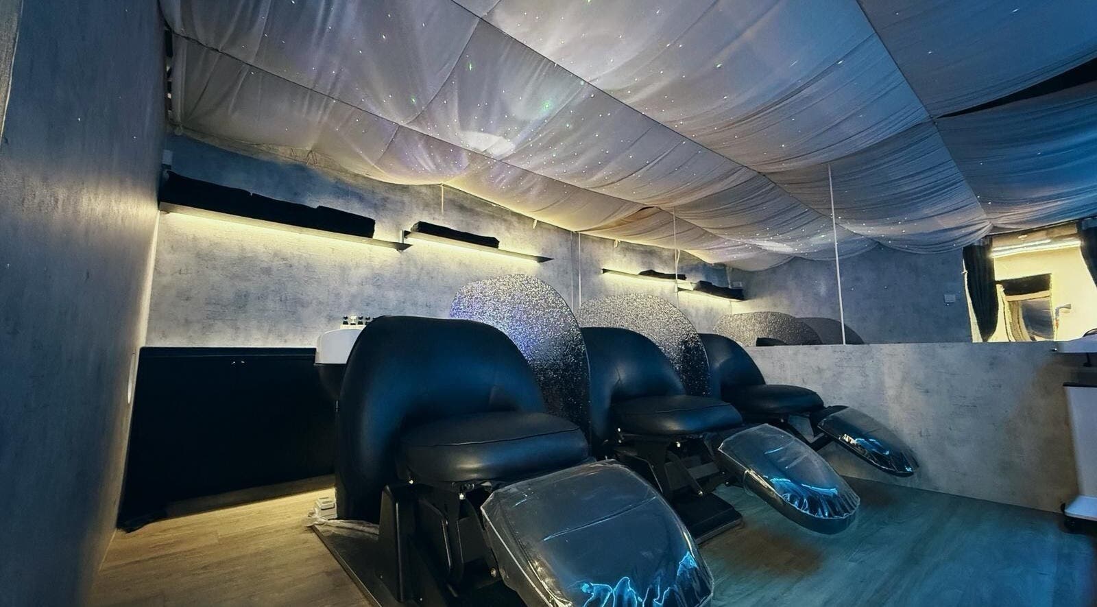 Elegant salon chairs under a star-like ceiling at 7percent hair studio, Singapore, Singapore, SG.