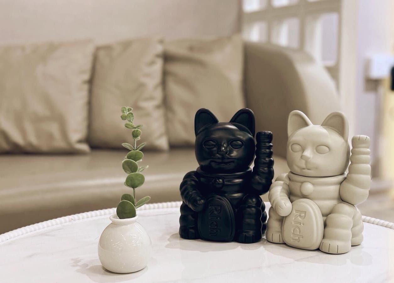 Stylish cat figurines and plant at 7percent hair studio, Singapore, SG, enhancing a serene ambiance.
