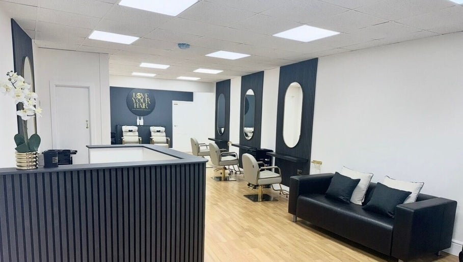 Elegant interior of Love Your Hair salon in Totton, England, GB featuring chic styling chairs and mirrors.
