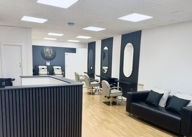 Elegant interior of Love Your Hair salon in Totton, England, GB featuring chic styling chairs and mirrors.