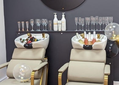 Elegant salon chairs with champagne at Love Your Hair in Totton, England, GB.