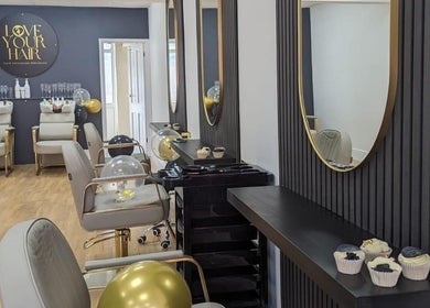 Stylish interior of Love Your Hair salon in Totton, England, GB with elegant chairs and modern decor.