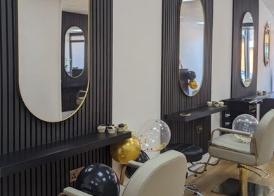 Modern styling area at Love Your Hair, Totton, England, GB, featuring chic mirrors and comfortable chairs.