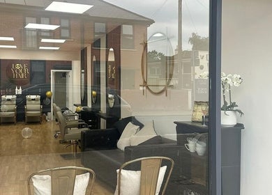 Love Your Hair salon in Totton, England, GB with chic and modern interior design visible through glass window.