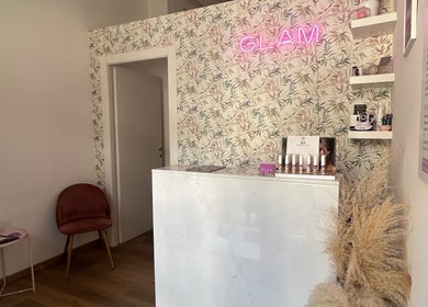 Entrata di GLAM Estetica & Benessere a Grottaglie, Puglia, IT, con decorazione elegante e pannello floreale.