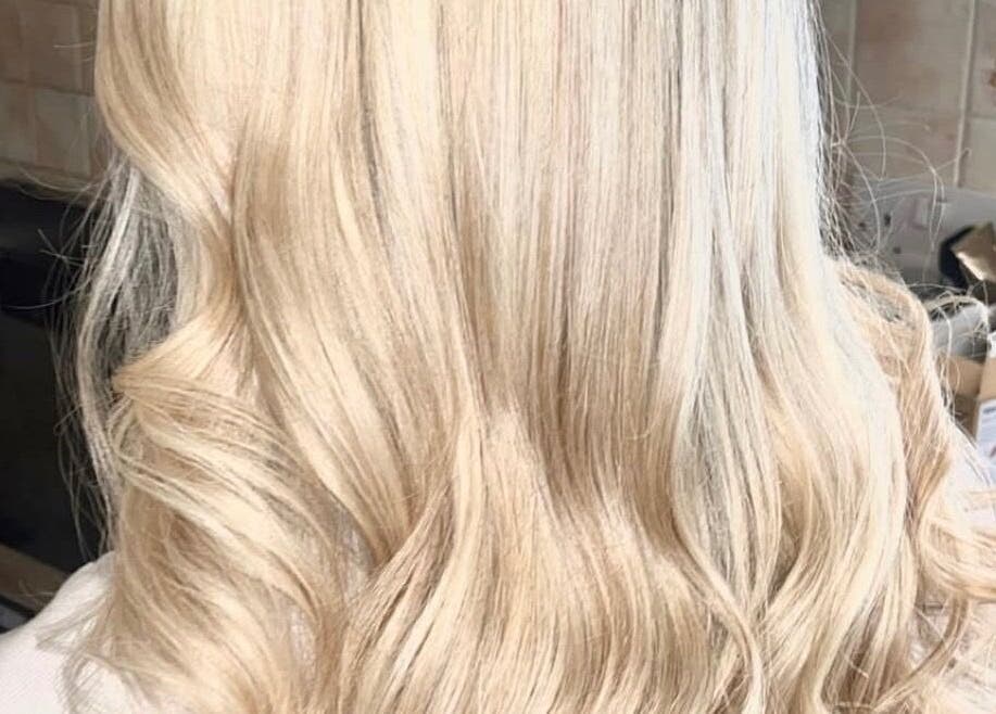 Blonde hair with flowing waves at K L Hair, Dunmurry, Northern Ireland, GB.