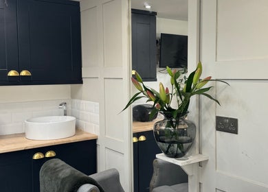 Elegant interior of The Garden Salon in Swindon, England, GB with a modern sink and decorative flowers.