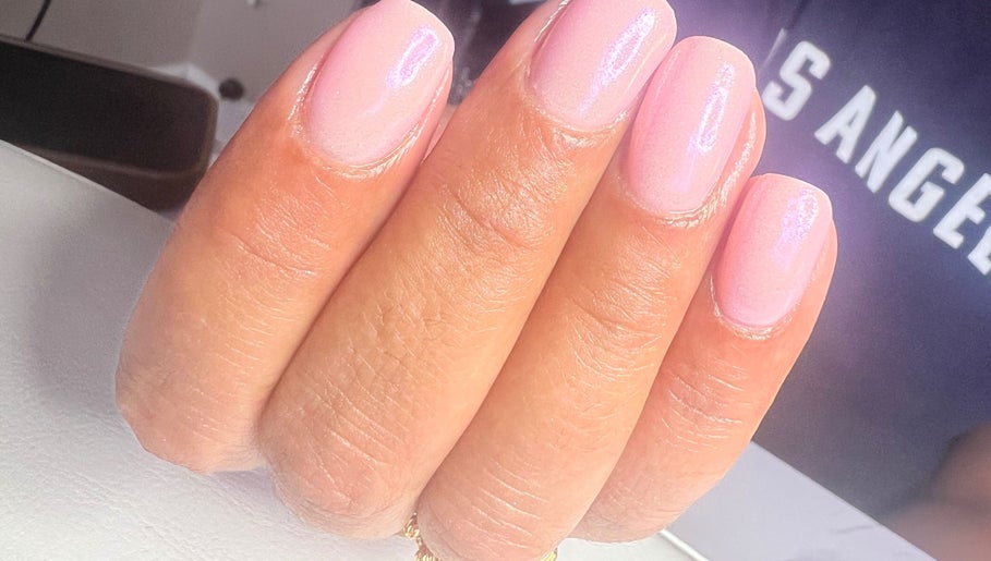 Elegant pink nails manicure at NailsbySa in Cardiff, Wales, GB showcasing shimmering nail art.