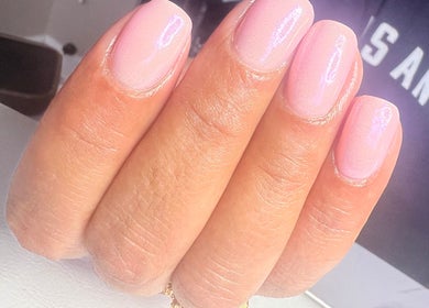 Elegant pink nails manicure at NailsbySa in Cardiff, Wales, GB showcasing shimmering nail art.