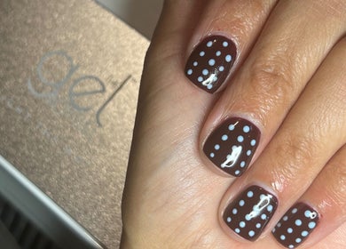 Polka dot nail art from NailsbySa in Cardiff, Wales, GB showcasing trendy brown and white design.