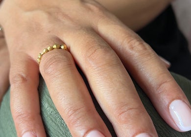 Close-up of elegant manicure with gold ring at NailsbySa, Cardiff, Wales, GB.