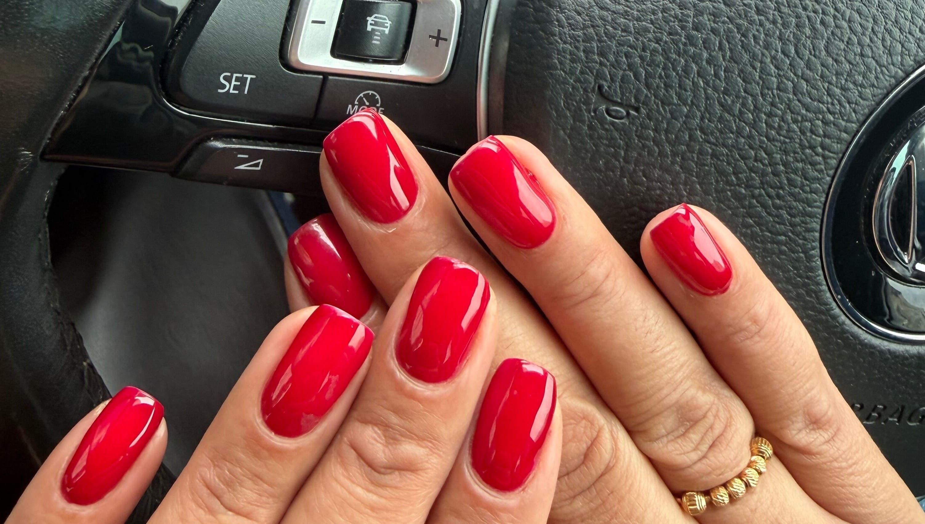 Stunning glossy red manicure at NailsbySa, Cardiff, Wales, GB. Perfectly polished and vibrant nail art.
