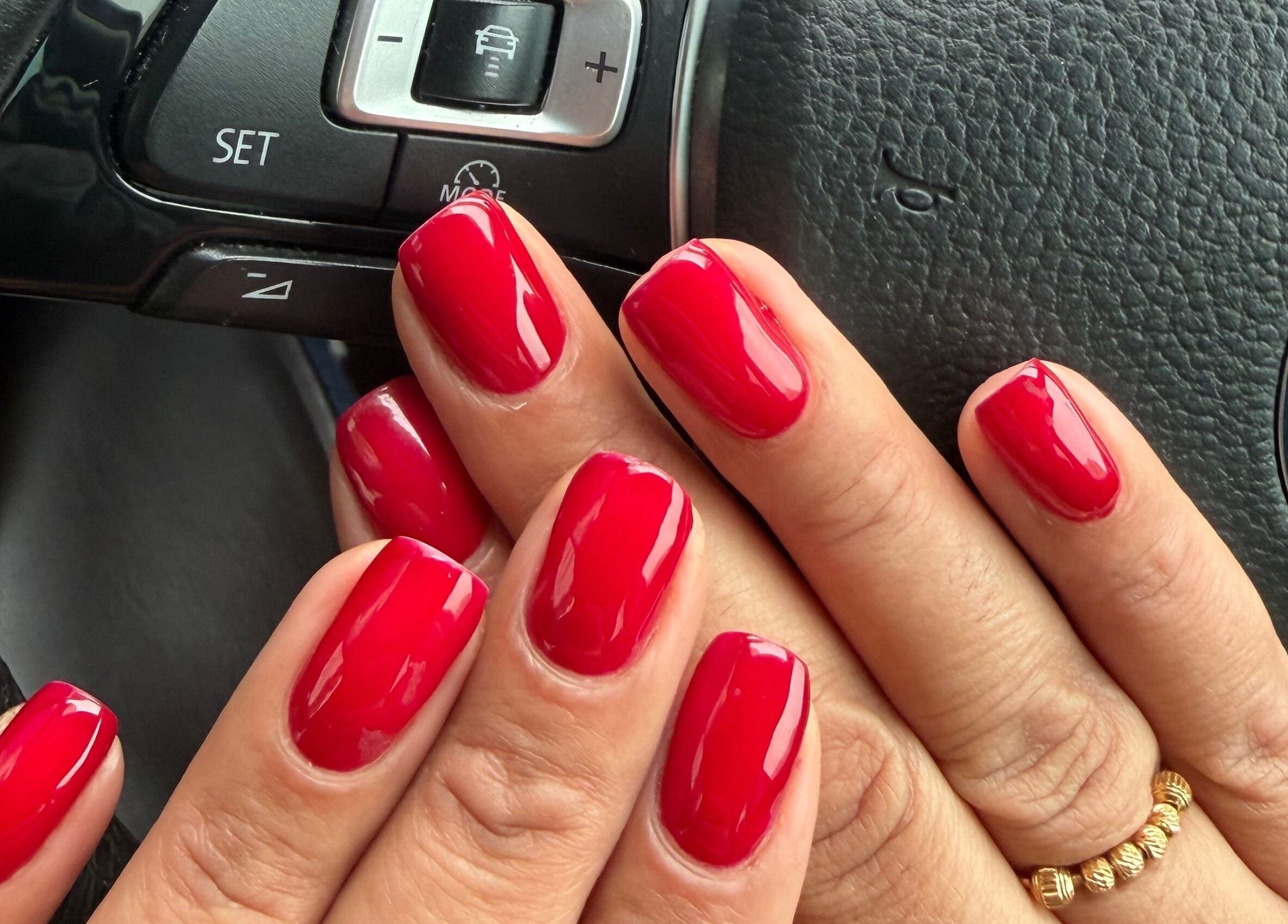 Stunning glossy red manicure at NailsbySa, Cardiff, Wales, GB. Perfectly polished and vibrant nail art.