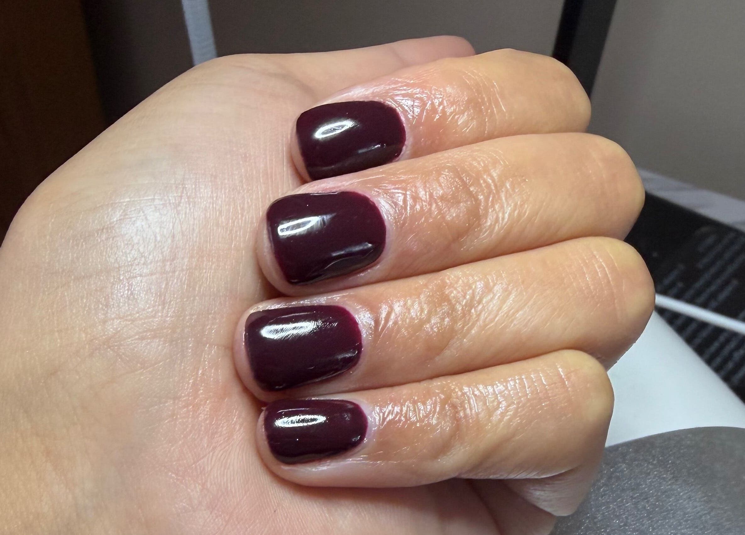 Elegant maroon manicure showcased at NailsbySa, Cardiff, Wales, GB, highlighting glossy finish and precision.