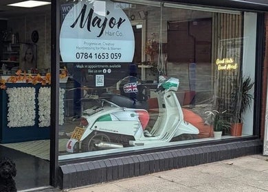 Front of Haus Of Leigh At Major Hair Co. in Leeds, England, GB, showcasing window display and a parked scooter.