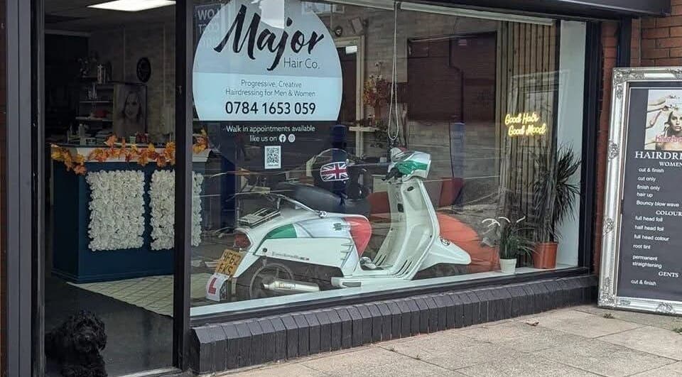 Front of Haus Of Leigh At Major Hair Co. in Leeds, England, GB, showcasing window display and a parked scooter.