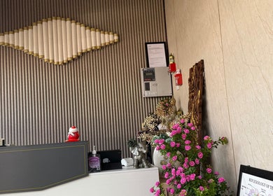 Kenton Thai Massage Therapy Ltd. London reception desk with decor and flowers.