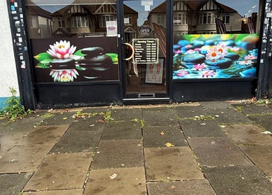 Front view of Kenton Thai Massage Therapy Ltd. in London, England, GB adorned with lotus artwork.