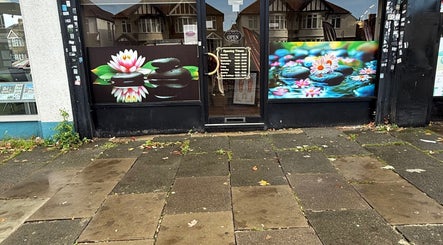 Front view of Kenton Thai Massage Therapy Ltd. in London, England, GB adorned with lotus artwork.