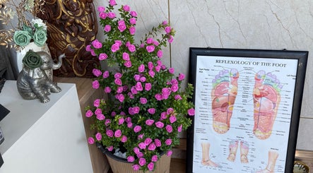 Decorative elements at Kenton Thai Massage Therapy Ltd., London, England, GB featuring foot reflexology chart and flowers.