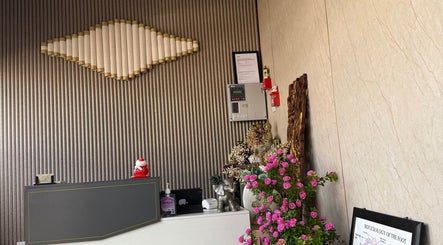 Reception area of Kenton Thai Massage Therapy Ltd. in London, England, GB featuring elegant decor and floral accents.