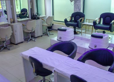Modern salon interior at Strands On Fleek Hair & Nail Bar, Nairobi, Nairobi, KE with black and beige chairs.