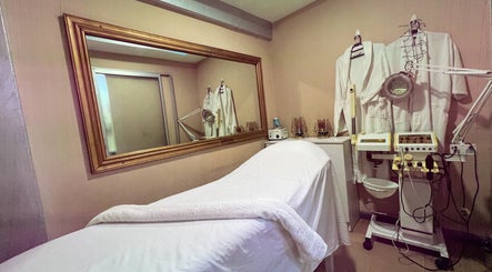 Relaxing spa room at Strands On Fleek Hair & Nail Bar, Nairobi, Nairobi, KE showcasing a massage bed and equipment.