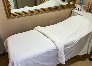 Massage table at Strands On Fleek Hair & Nail Bar, Nairobi, Nairobi, KE, ready for a relaxing spa session.