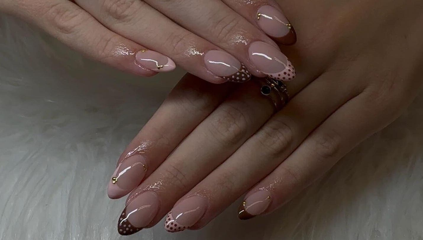 Polished nails with a chic dotted design at Klawedbykat, Swaffham, England, GB.