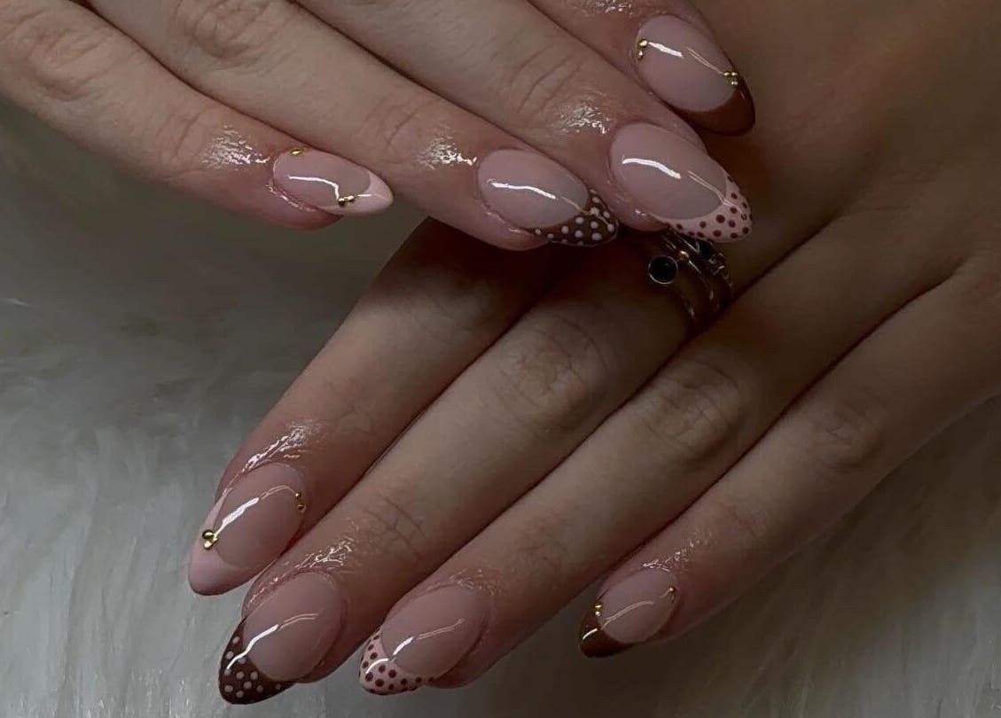 Polished nails with a chic dotted design at Klawedbykat, Swaffham, England, GB.