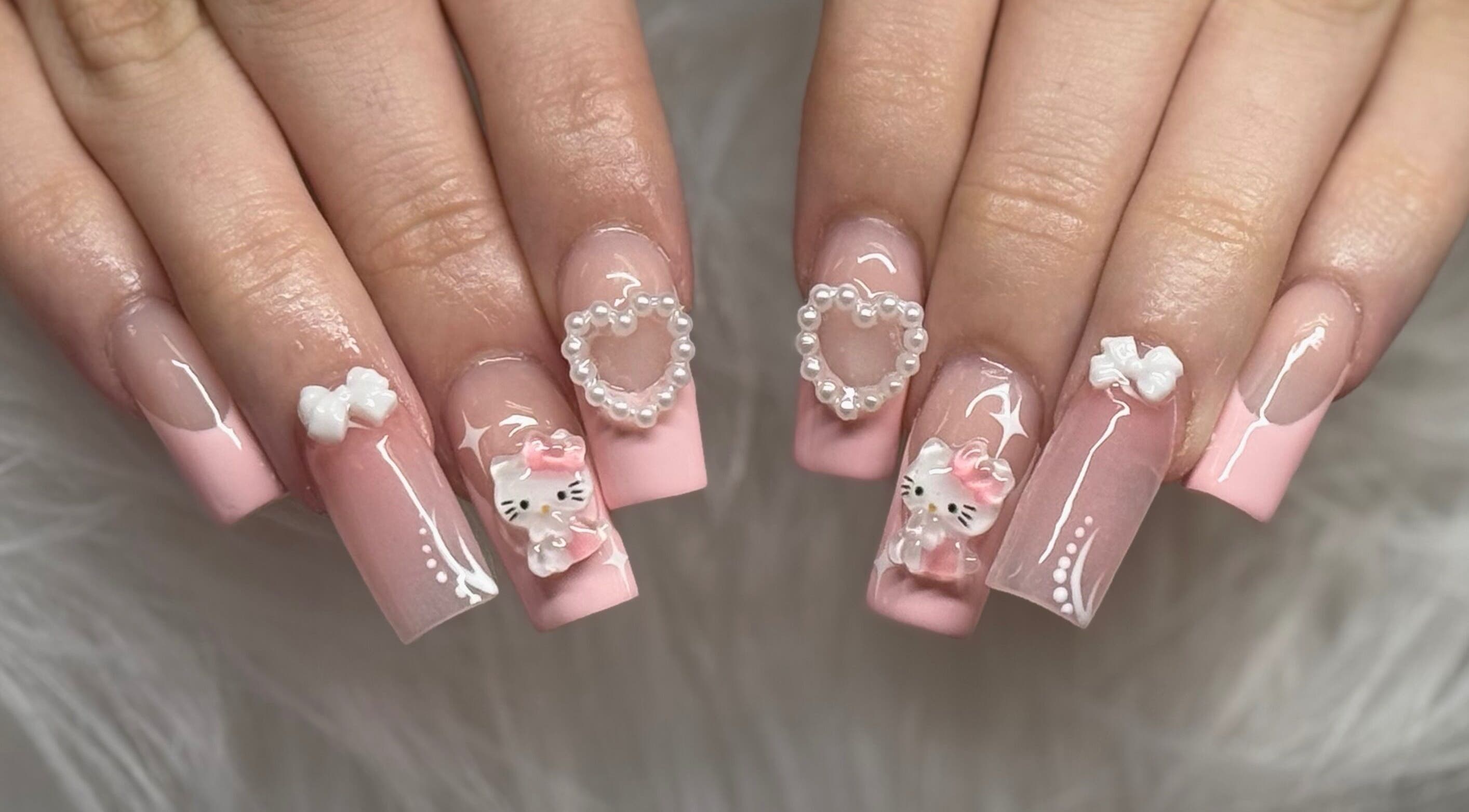 Elegant pink nail design with cute charms at Klawedbykat, Swaffham, England, GB.