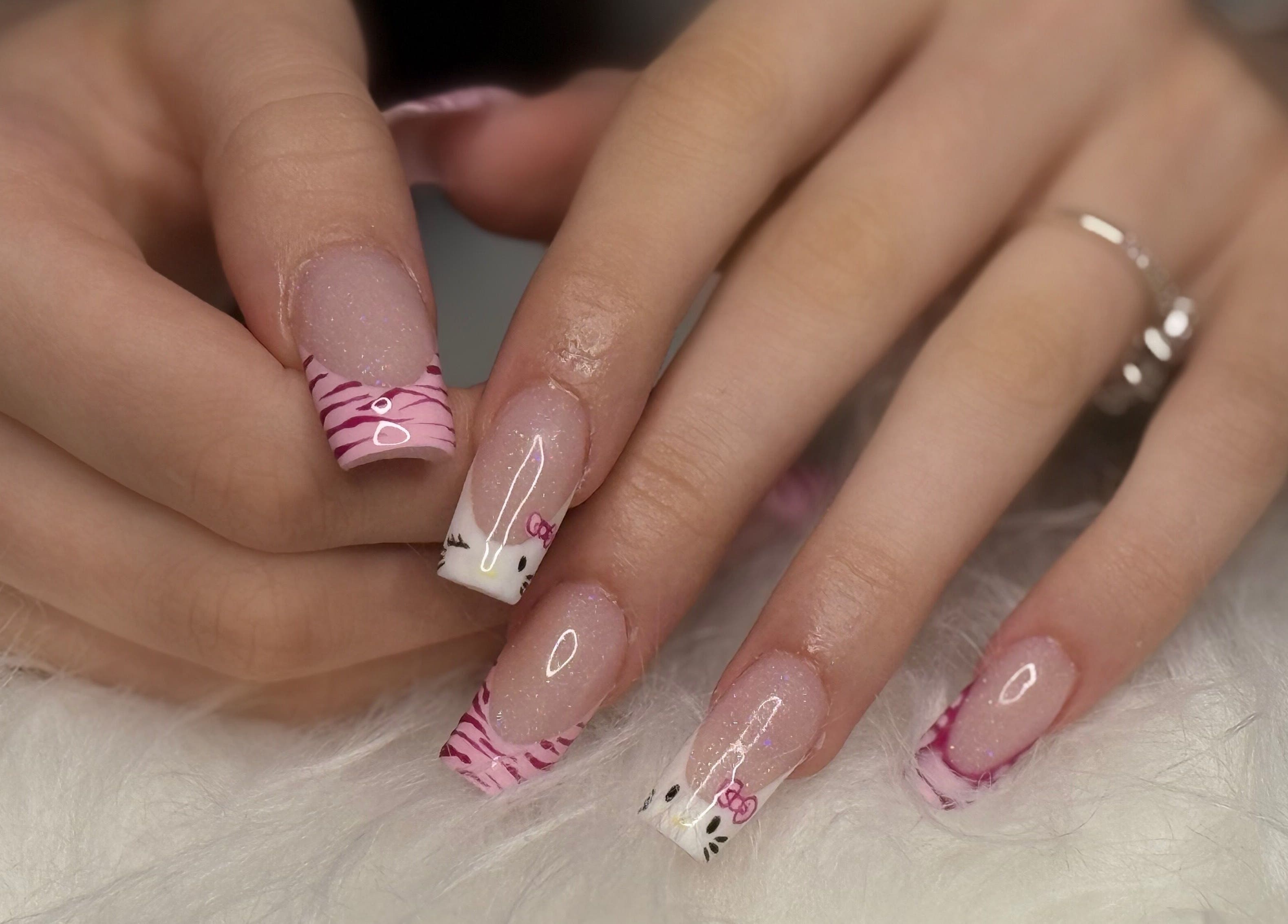Stylish nail art with pink and white designs at Klawedbykat, Swaffham, England, GB.