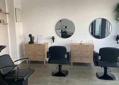 Modern salon interior with chic chairs and mirrors at KOZY, Hindley, England, GB, creating a serene atmosphere.