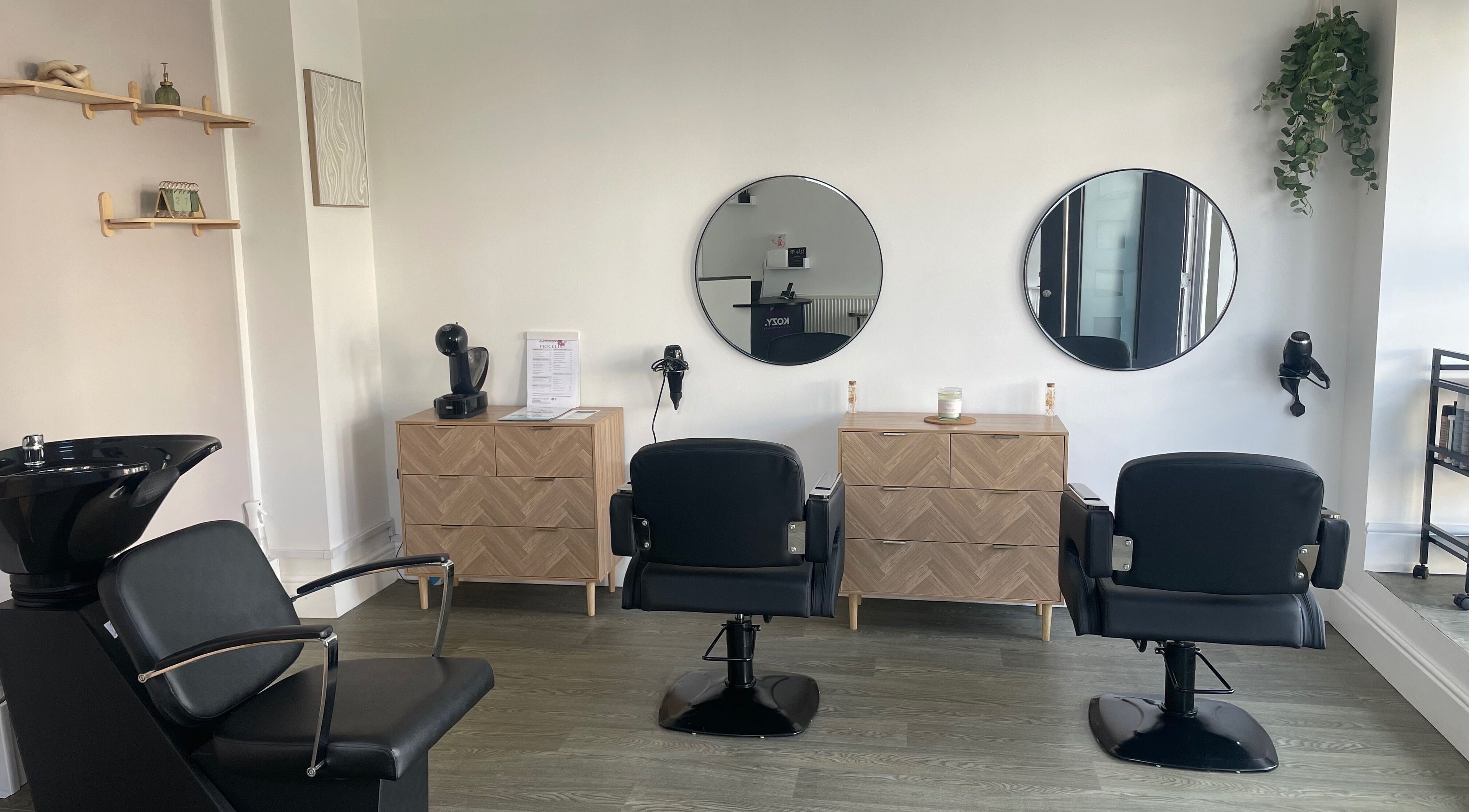 Modern salon interior with chic chairs and mirrors at KOZY, Hindley, England, GB, creating a serene atmosphere.