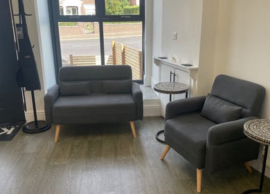 Modern seating area in KOZY, Hindley, England, GB with stylish sofas and tables.