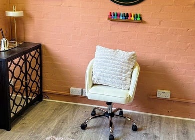 Cozy salon corner at NailedItByLarna with a plush chair and decor in Redditch, England, GB.