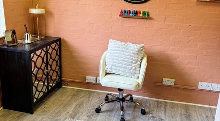 Cozy salon corner at NailedItByLarna with a plush chair and decor in Redditch, England, GB.