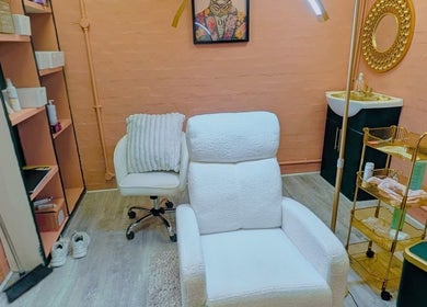 Inviting treatment room at BROWSByLarna in Redditch, England, GB with plush chairs and elegant decor.