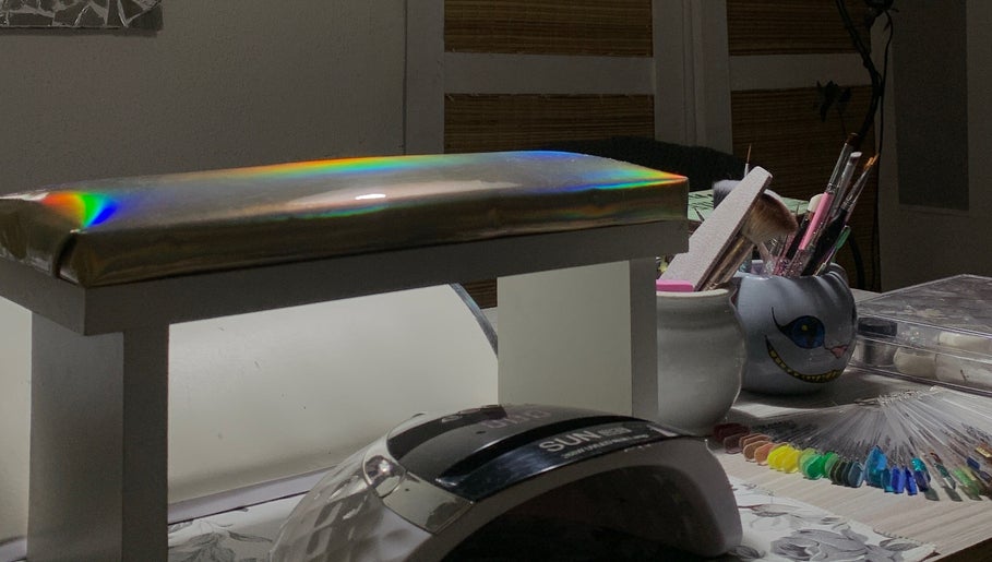 Sky Nails workspace in Pablo Podesta, glowing light on nail tools and color samples.