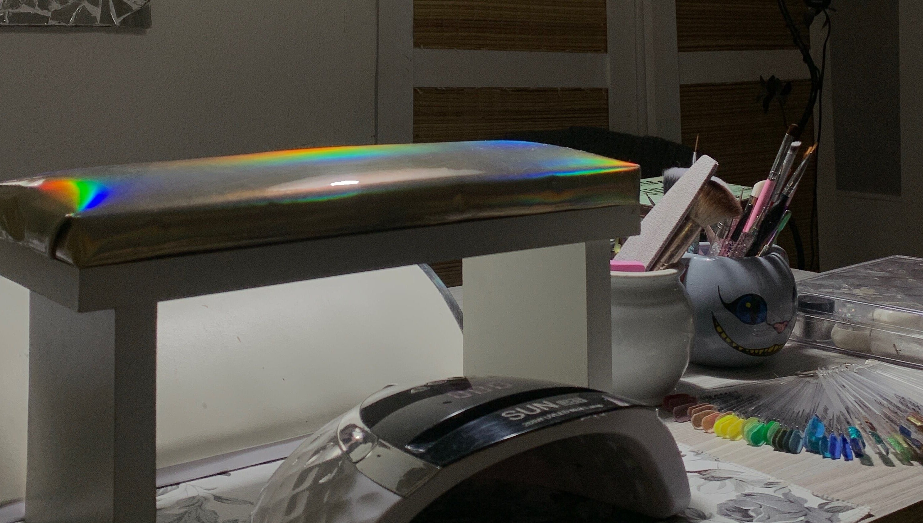 Sky Nails workspace in Pablo Podesta, glowing light on nail tools and color samples.