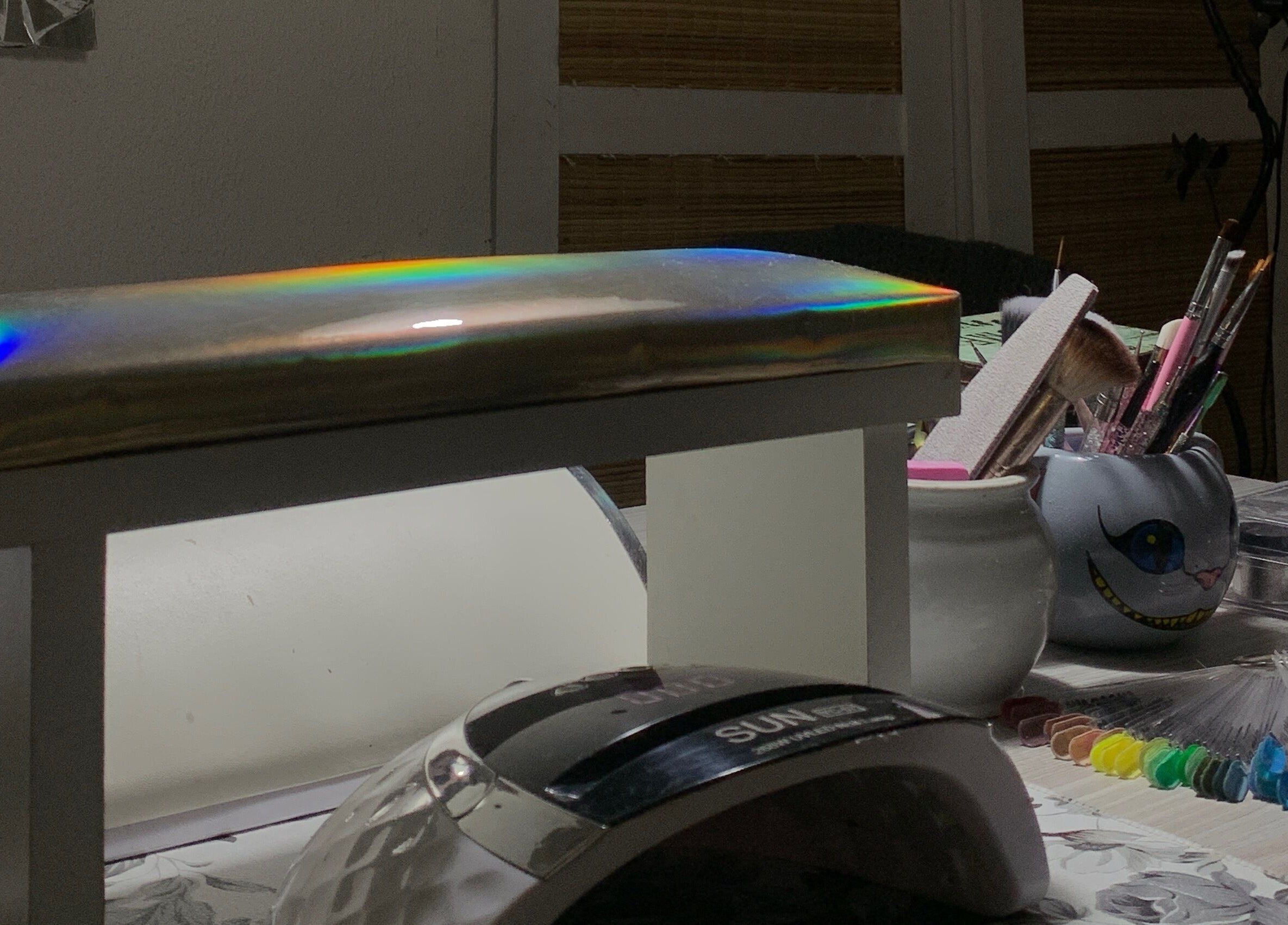 Sky Nails workspace in Pablo Podesta, glowing light on nail tools and color samples.