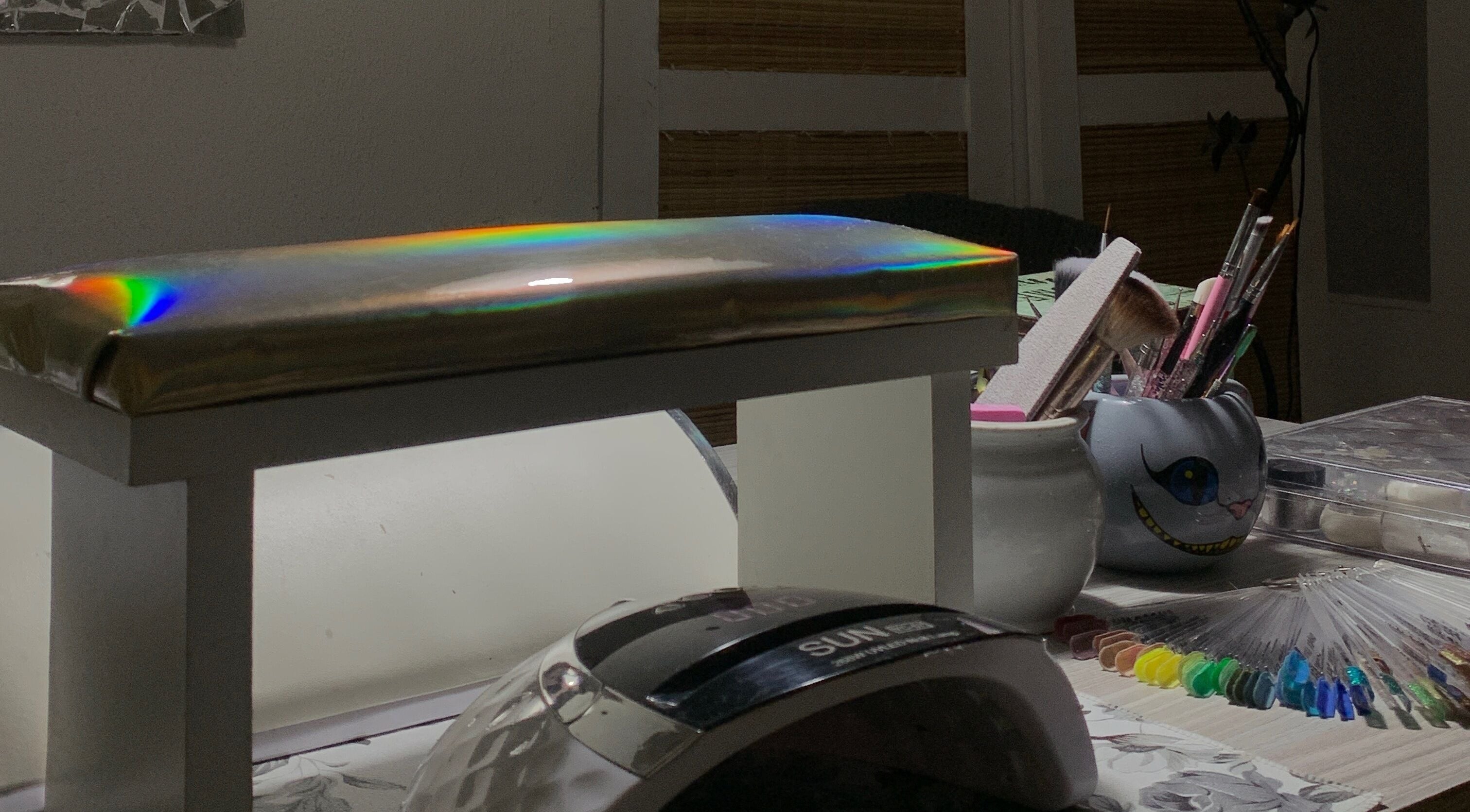 Sky Nails workspace in Pablo Podesta, glowing light on nail tools and color samples.