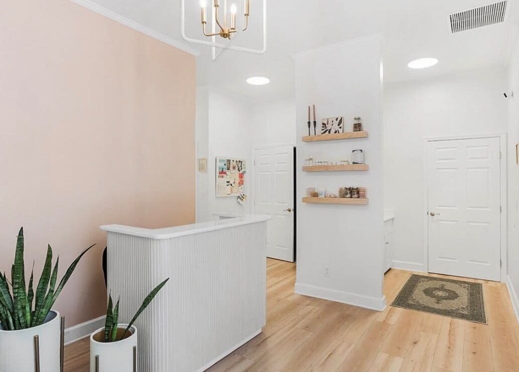 Reception area of LOR Beauty Concept in Jacksonville, Florida, featuring soft tones and minimalist decor.