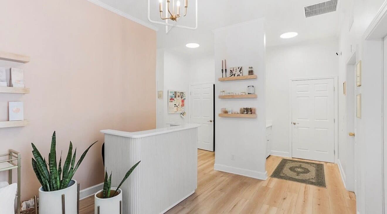 Reception area of LOR Beauty Concept in Jacksonville, Florida, featuring soft tones and minimalist decor.