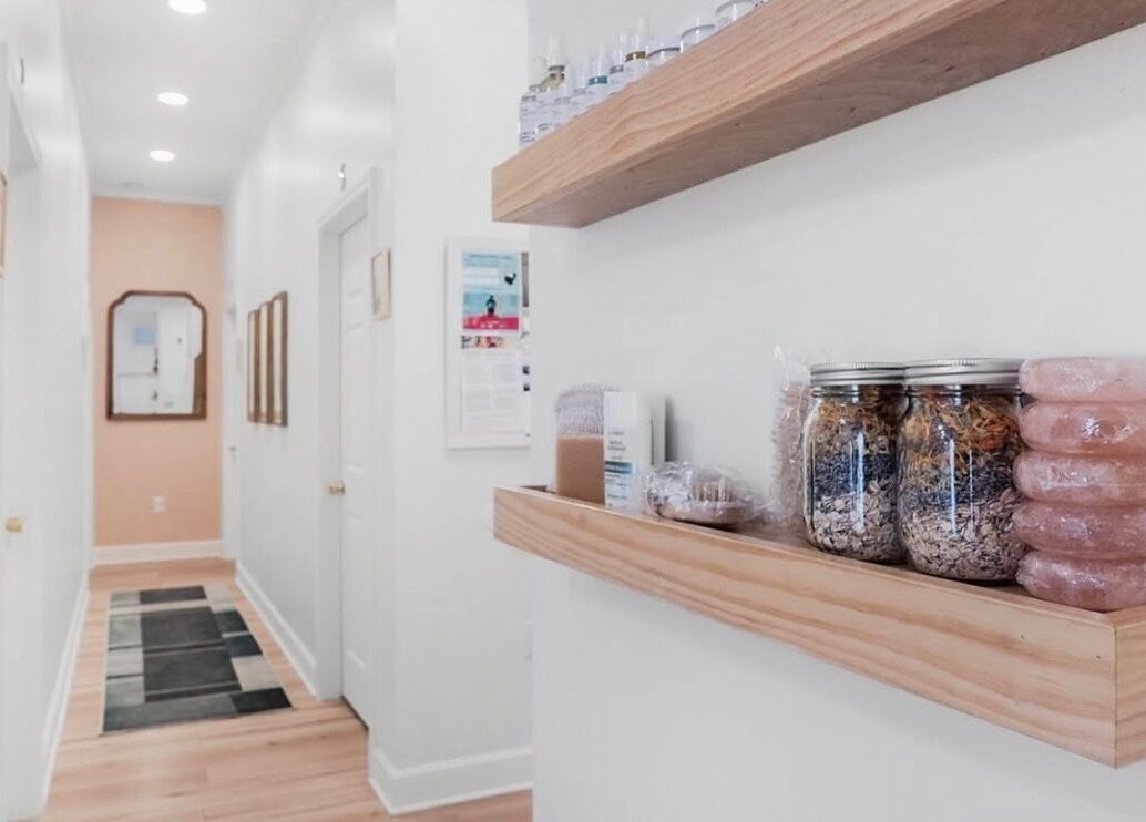 Elegant hallway at LOR Beauty Concept in Jacksonville, Florida, US, with natural beauty products displayed on shelves.